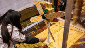 Jaidyn Ramirez prepares her team’s wind turbine design for testing during a KidWind Challenge.